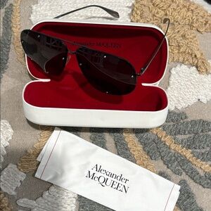 Alexander McQueen!There are a couple of scratches on the inside of the lens